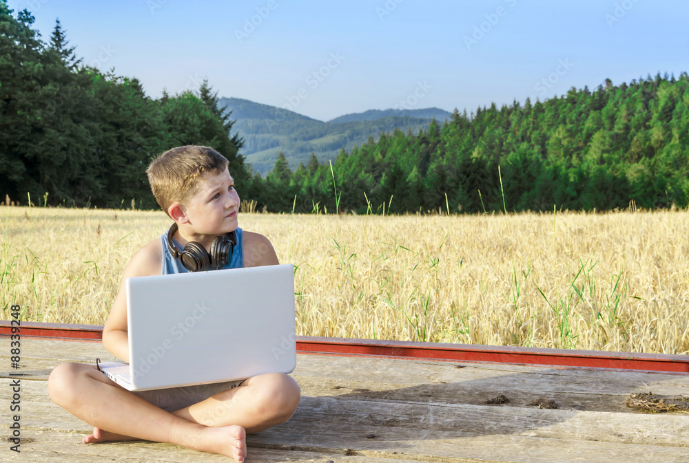 Country boy with gadgets in the field. Country boy with gadgets in the field.