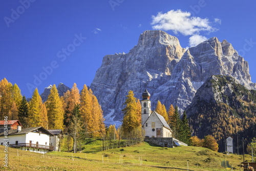 The tiny Church of Selva di Cadore, in the Dolomites, in autumn with the majestic Monte Pelmo in the background, Veneto photo