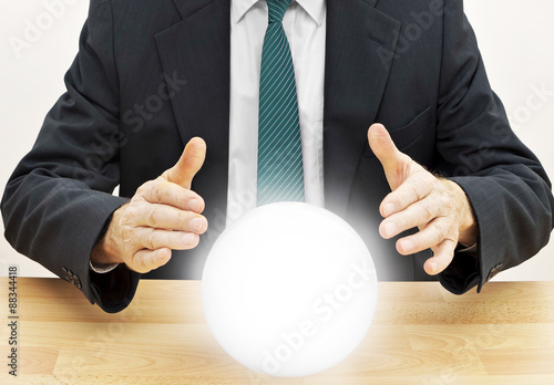 Quadro su tela Fortune teller businessman predicting future with crystal ball