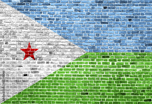 Flag of Djibouti painted on brick wall, background texture photo