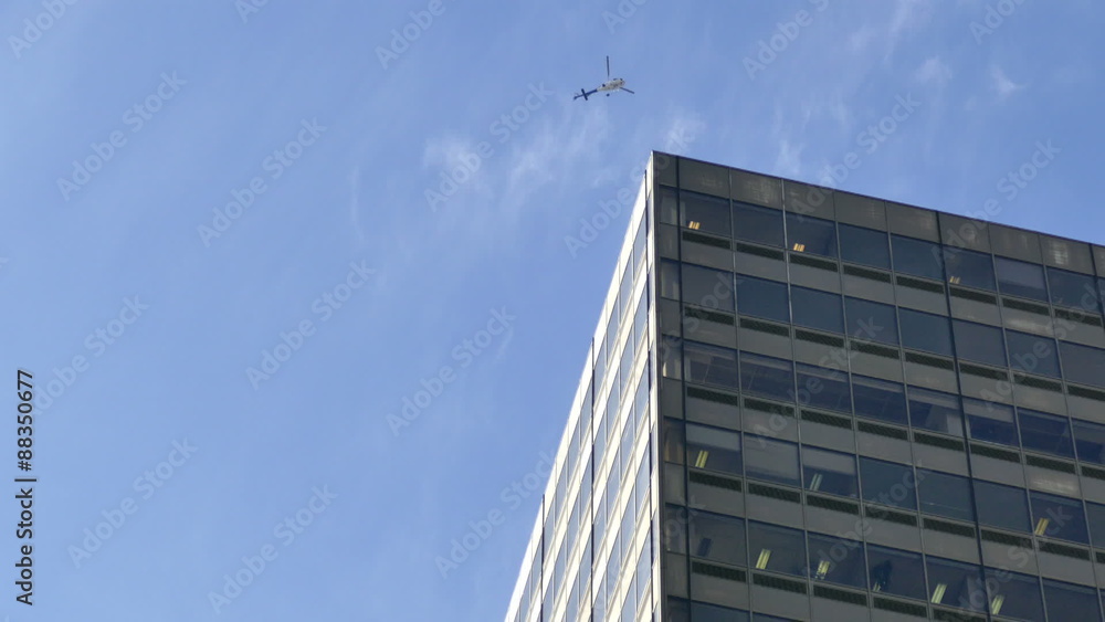 Surveillance helicopter flying around building corner Surveillance helicopter flying around building corner