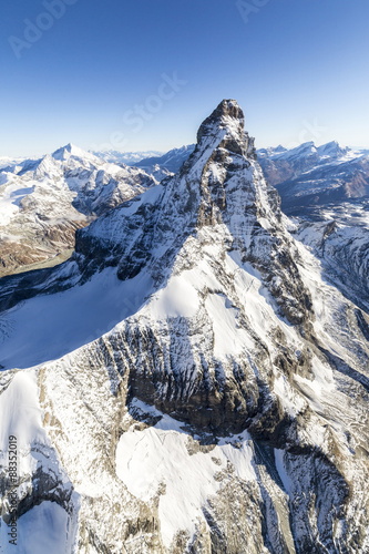 The unique shape of the Matterhorn sorrounded by its mountain range covered in snow, Swiss Canton of Valais, Swiss Alps photo