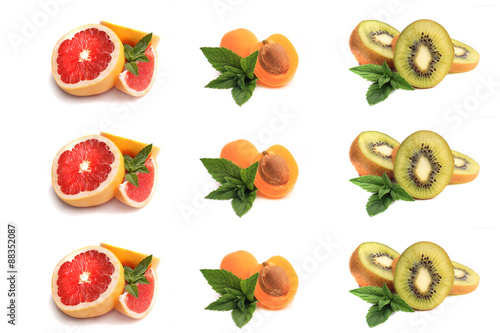 Fototapeta Naklejka Na Ścianę i Meble -  grapefruit,apricot, slices of ripe kiwi with mint leaves on a wh