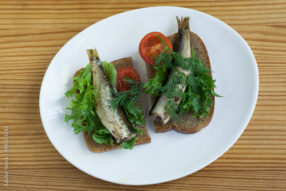 sprats, bread and tomatoes on a saucer sprats, bread and tomatoes on a saucer