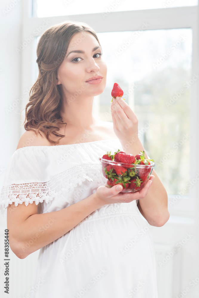Beautiful pregnant woman having a cup of coffee. Beautiful pregnant woman having a cup of coffee.