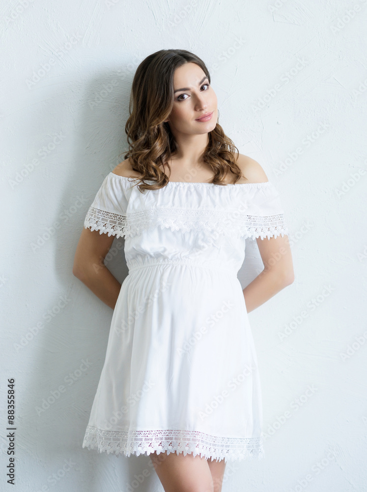 Beautiful pregnant woman on white background.