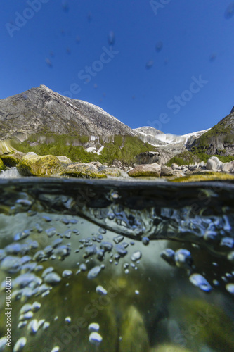 Above and below view of ice melt waterfall cascading down in Svartisen National Park, Melfjord, Nordfjord photo