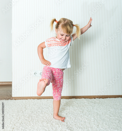 Fototapeta Naklejka Na Ścianę i Meble -  happy little  girl engaged in physical activity 
