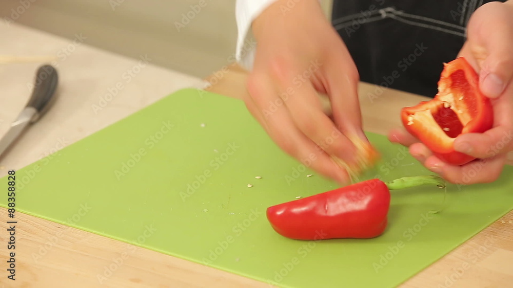 Cheff is Cutting Red Paprika on a Cutting Board Cheff is Cutting Red Paprika on a Cutting Board