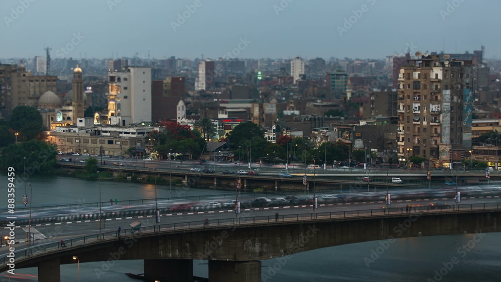 Time lapse of traffic in Cairo center, day to night transition. The 15th May Bridge / 26th July Corridor in the foreground, the Corniche in the background Time lapse of traffic in Cairo center, day to night transition. The 15th May Bridge / 26th July Corridor in the foreground, the Corniche in the background