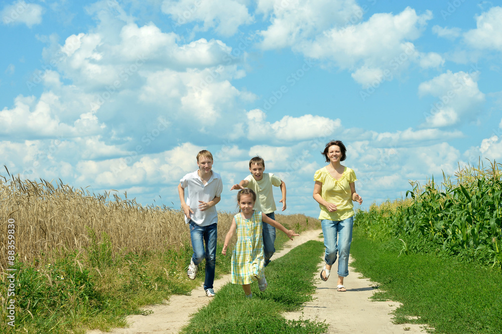 Happy family jumping on field 