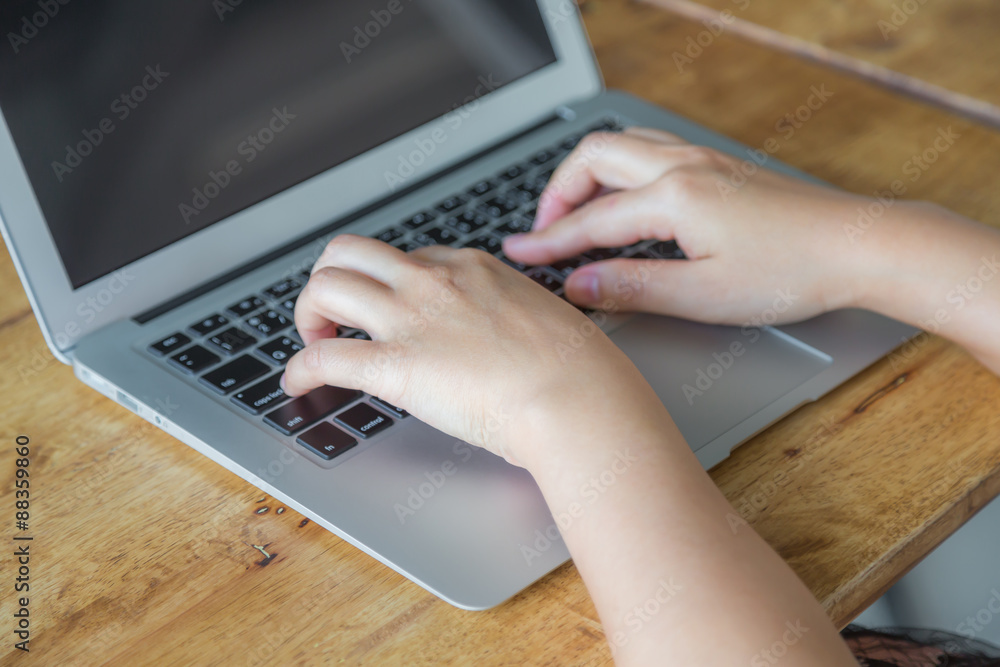 Fototapeta premium Closeup of business woman hand typing on laptop keyboard