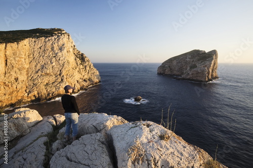 Woman enjoying the sunset, Capo Caccia, Province Nurra, Sardinia, Mediterranean  photo