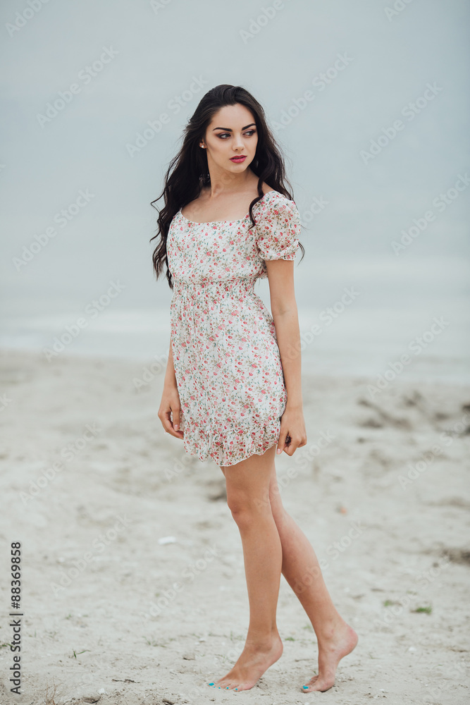 Beautiful and curly girl posing on a background of water Beautiful and curly girl posing on a background of water