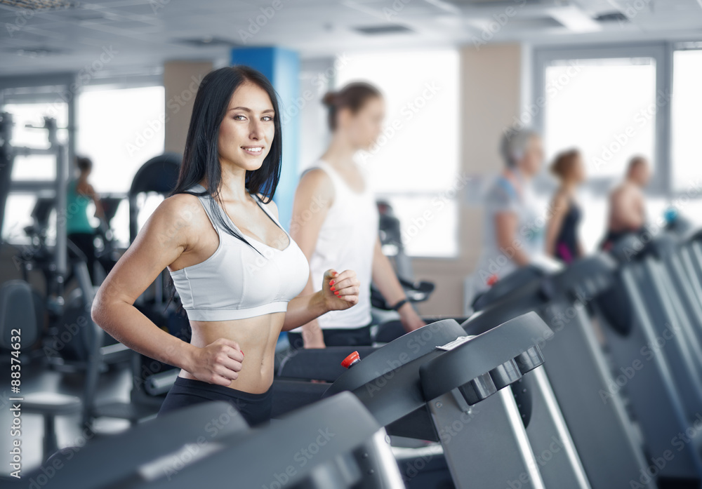 Portrait of pretty girl training on special sport equipment in g Portrait of pretty girl training on special sport equipment in g