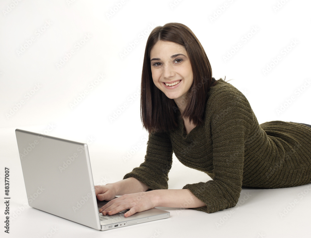 Attractive young woman lying on the floor with her laptop. Attractive young woman lying on the floor with her laptop.