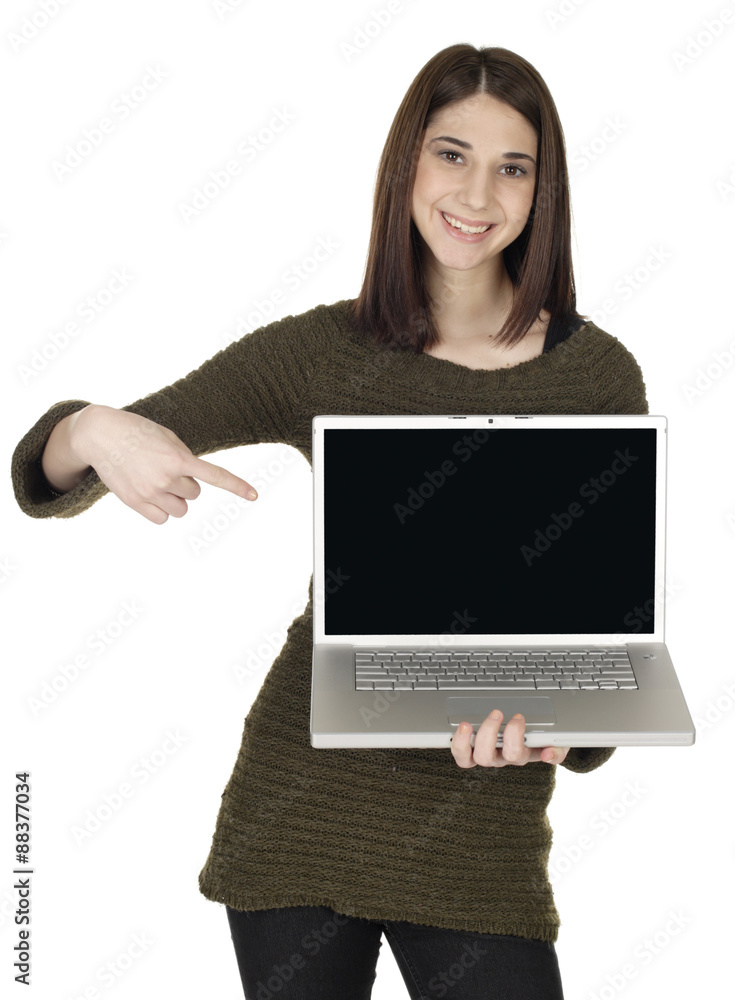 A woman smiles and holds a laptop while point to the blank screen. Put copy on the screen. A woman smiles and holds a laptop while point to the blank screen. Put copy on the screen.