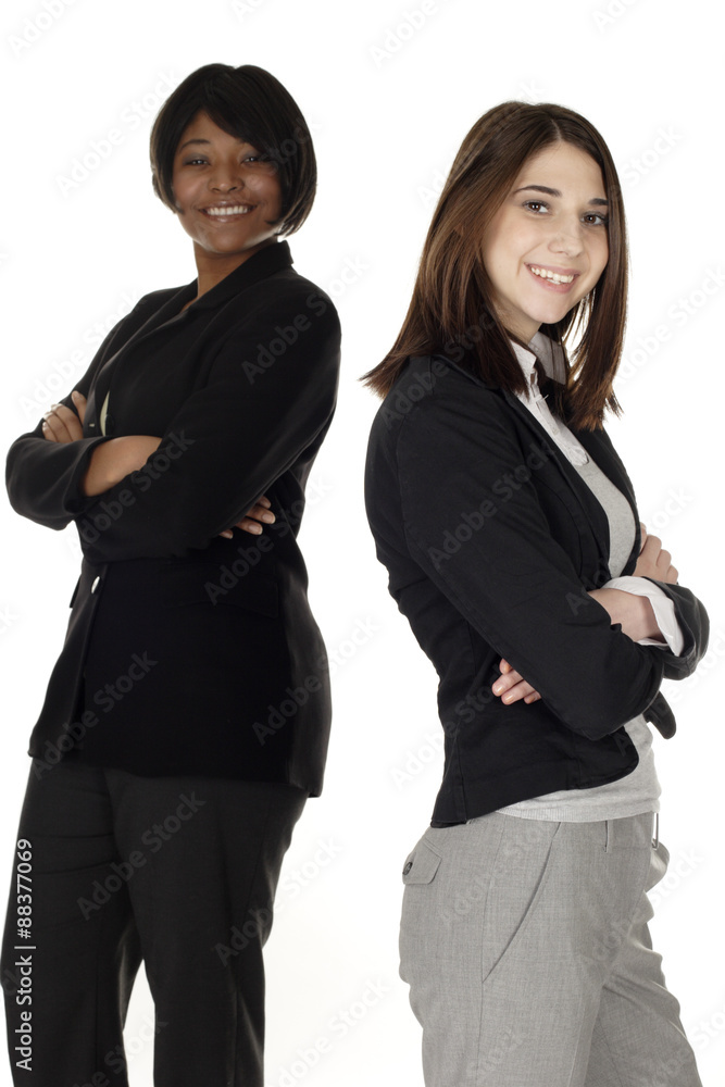 Two businesswomen standing with arms crossed. Focus is on woman in front. Two businesswomen standing with arms crossed. Focus is on woman in front.
