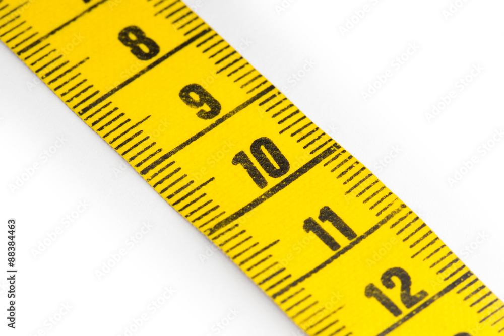 Yellow measuring tape isolated - selective focus Yellow measuring tape isolated - selective focus