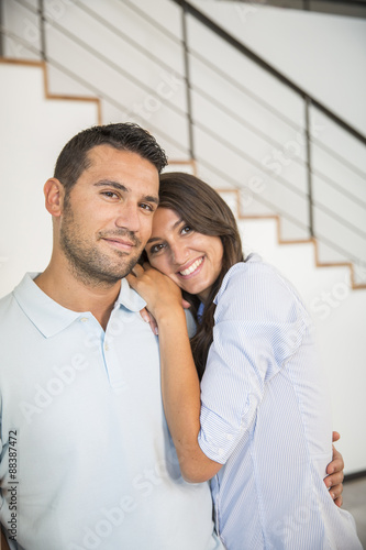 Smiling young couple in new home