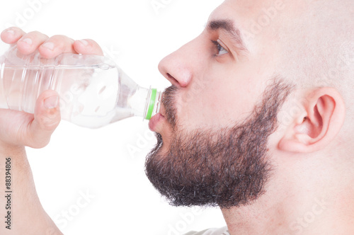 Close up with guy drinking water from plastic bottle