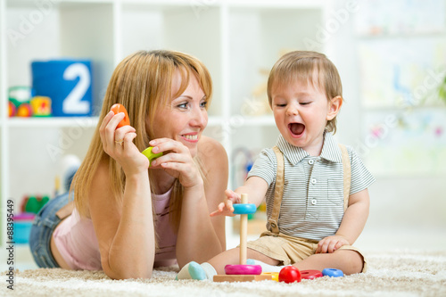 parent and baby boy playing...