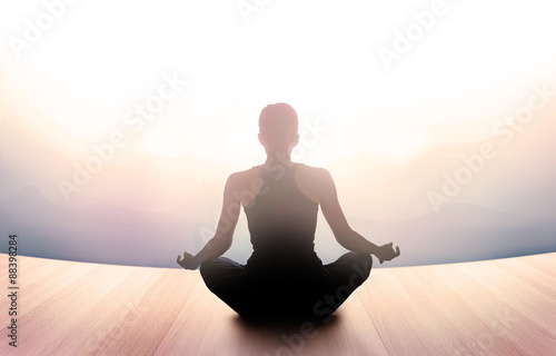 woman was meditating in morning and rays of light on landscape