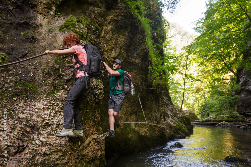 Hikers climbing above the river Hikers climbing above the river