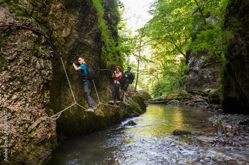 Hikers climbing above the river