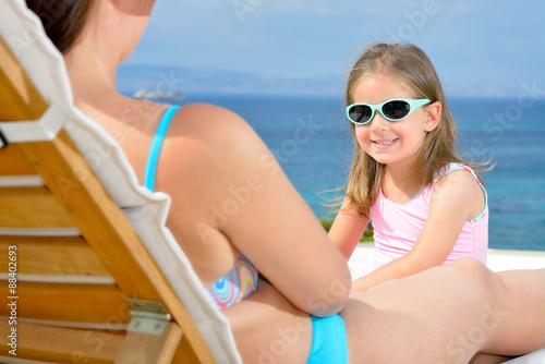 Real toddler girl relaxing on the sunbed