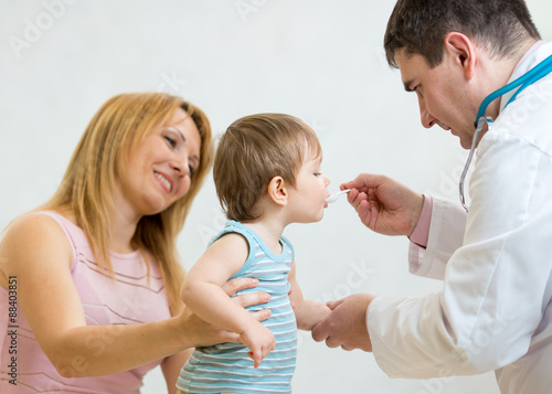 Doctor giving a spoon of sy...