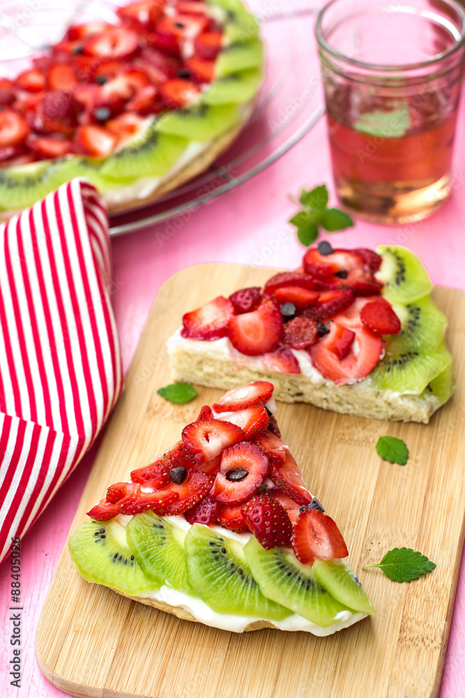 Sponge cake with strawberries and kiwi in shape of watermelon