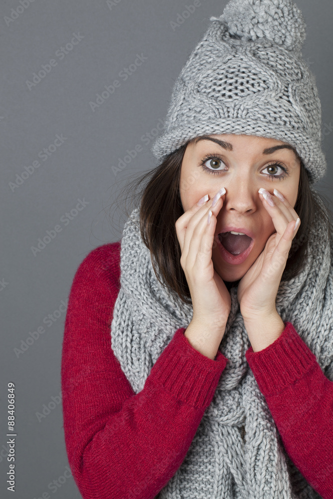 vocal concept - portrait of happy 20s woman with winter grey winter hat and scarf shouting with hands around mouth,studio shot vocal concept - portrait of happy 20s woman with winter grey winter hat and scarf shouting with hands around mouth,studio shot