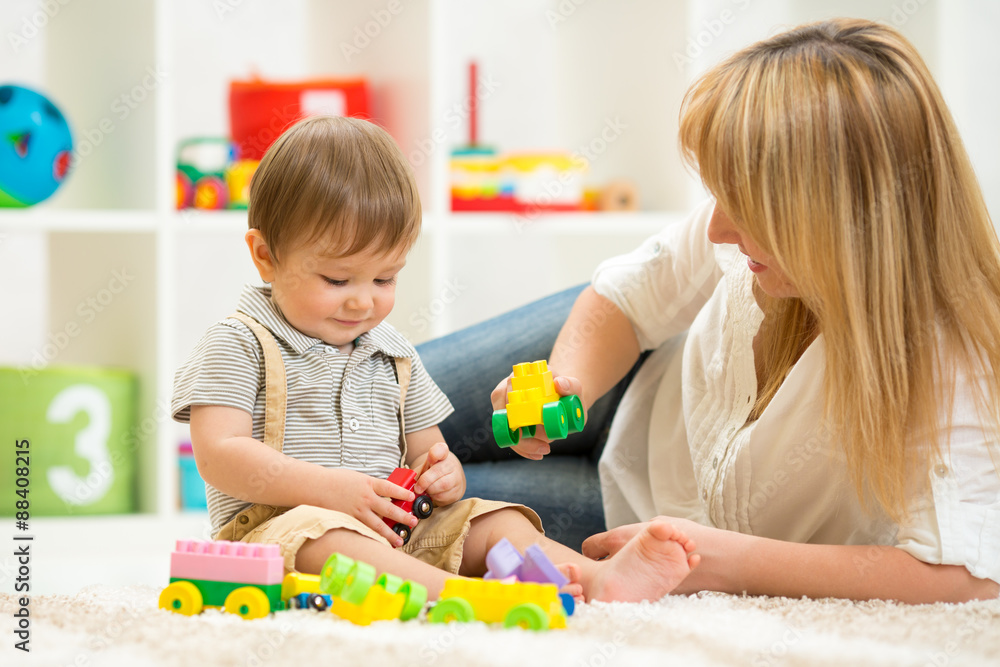 kid playing with building blocks at kindergarten kid playing with building blocks at kindergarten
