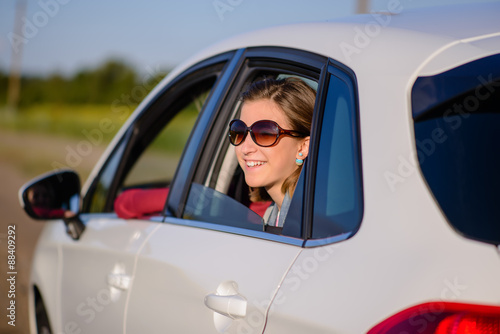 Smiling young woman on a road trip