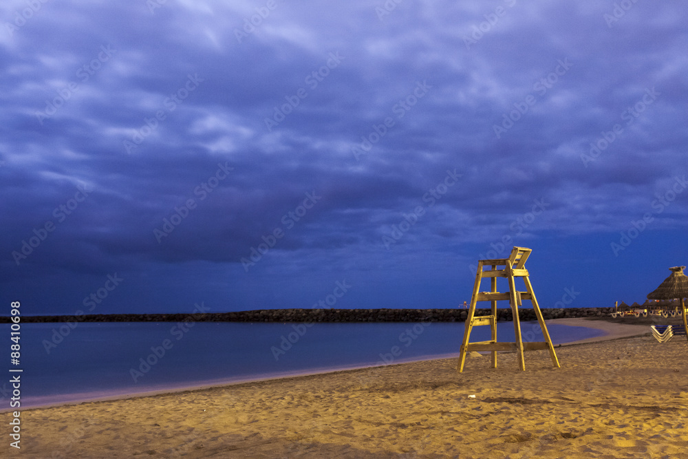 High wooden lifesaver chair on tropical sandy deserted beach night shoot High wooden lifesaver chair on tropical sandy deserted beach night shoot