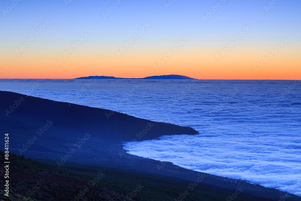 Aerial view over clouds above ocean water with last sunshine, Tenerife, Canary Islands, Spain Aerial view over clouds above ocean water with last sunshine, Tenerife, Canary Islands, Spain