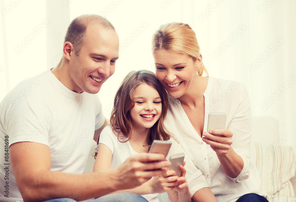 parents and little girl with smartphones at home parents and little girl with smartphones at home
