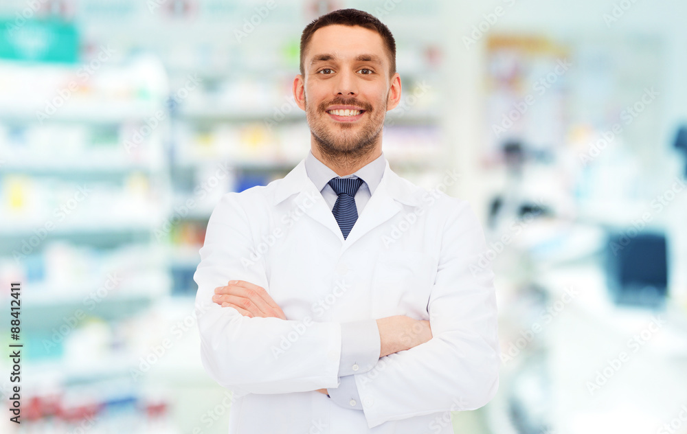 smiling male pharmacist in white coat at drugstore smiling male pharmacist in white coat at drugstore