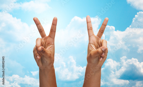 two african hands showing victory or peace sign