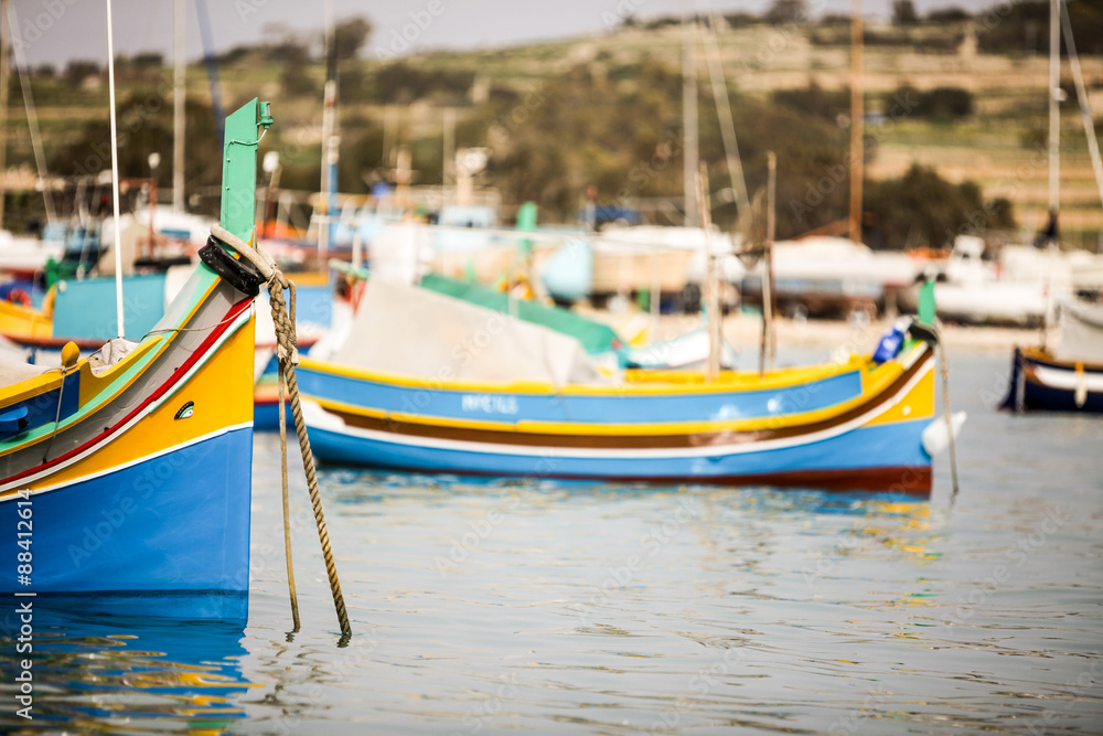 Maltese Luzzu fishing boat, Marsaxlokk, Malta. Maltese fishing boats decorated in their familiar bright colors with eyes painted on the bows.