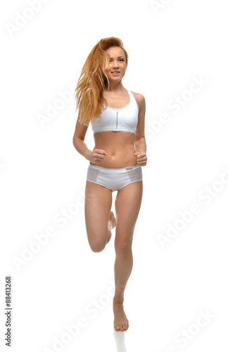 Happy young fitness beautiful slim sport woman jogging and runni photo