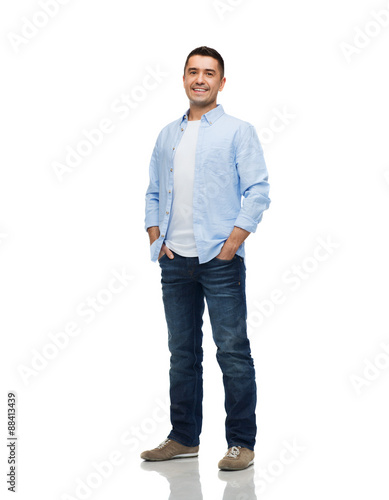 smiling man with hands in pockets