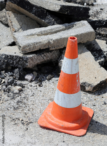 Traffic cone red stripes around the excavation photo