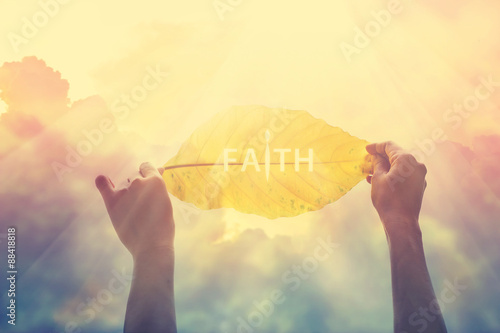 abstract, holding a yellow leaf in the clorful sky of faith, vintage tone photo