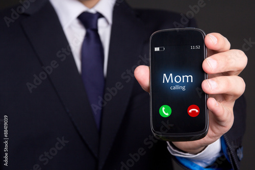 hand holding smart phone with incoming mother call