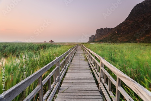 Wooden bridge cross around marsh in sunset time at Sam Roi Yot National Park Thailand