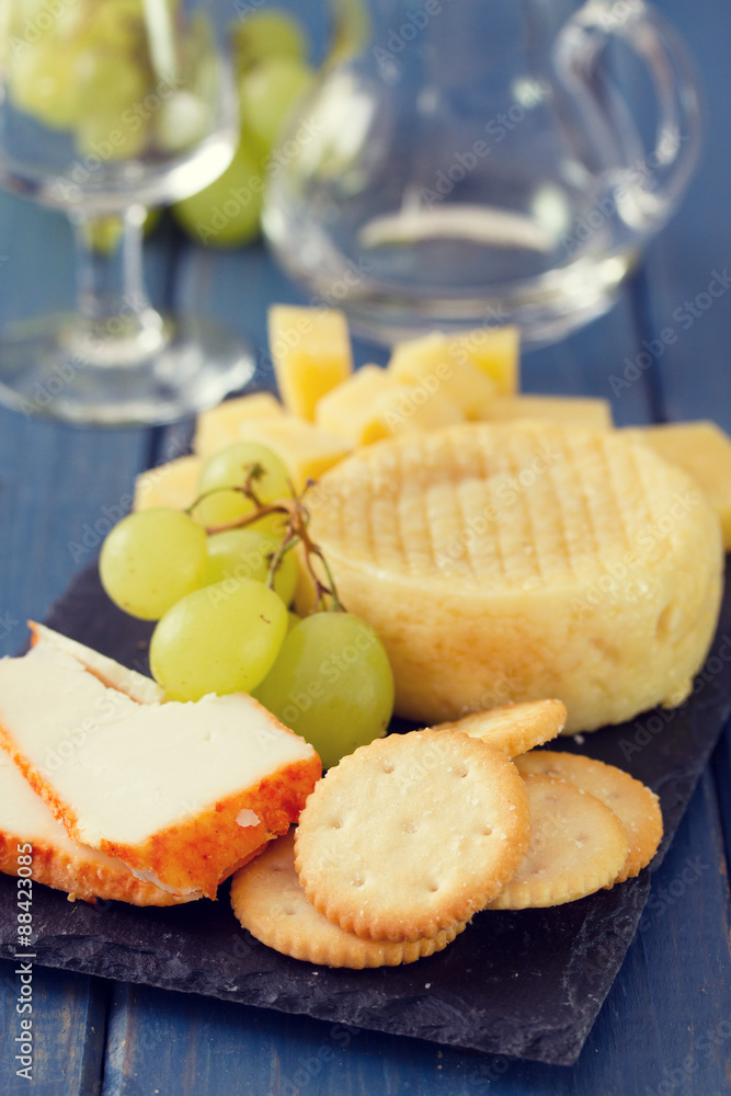 cheese with grapes and cookies and glass of white wine cheese with grapes and cookies and glass of white wine