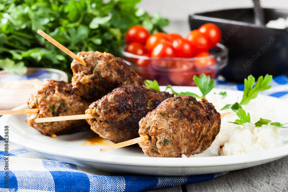 Barbecued kofta with rice on a plate Barbecued kofta with rice on a plate