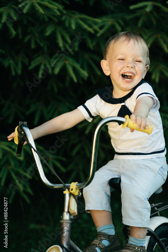 little happy boy on bike